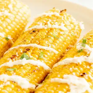 Grilled corn with garlic mayo & grated cheese